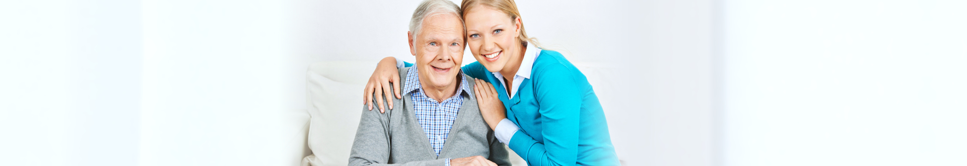 senior male smiling with caregiver