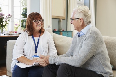 a caregiver talking with her senior patient