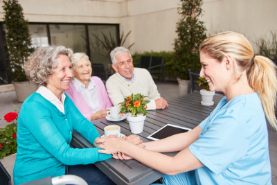 a caregiver having fun talking with her seniors patient