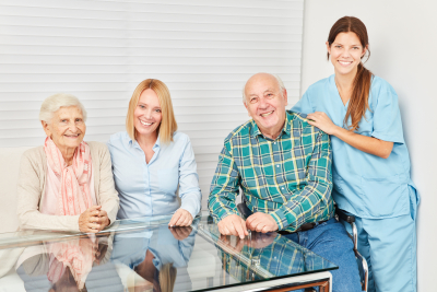 a caregiver and her senior patient watching somethin on the tablet