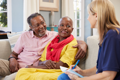 a caregiver and her senior patient watching somethin on the tablet