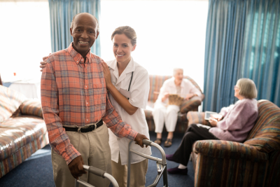 a caregiver assiting her senior patient walking