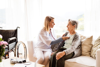 Health visitor and a senior woman during home visit