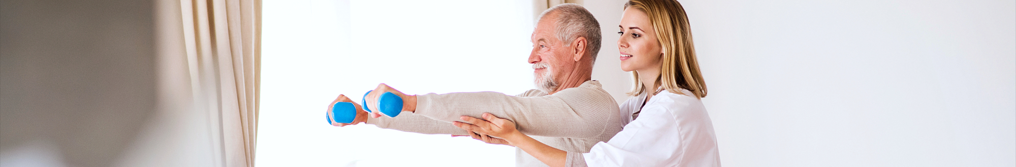 woman helping senior man exercise